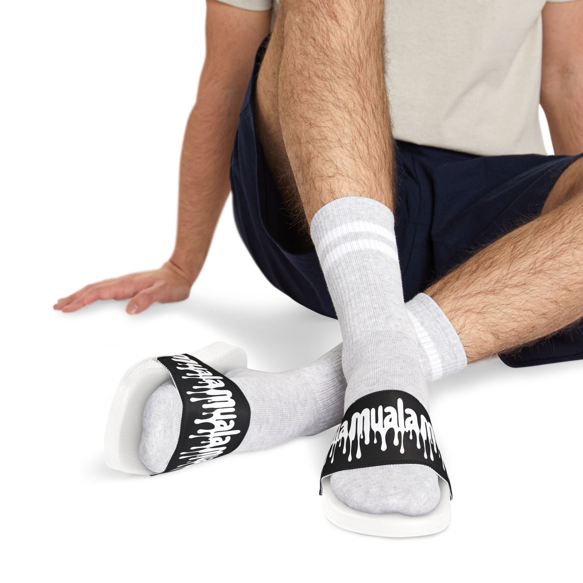 Muala® "flip fat flop" men's sandals with black adjustable straps and white cushioned sole worn with gray socks