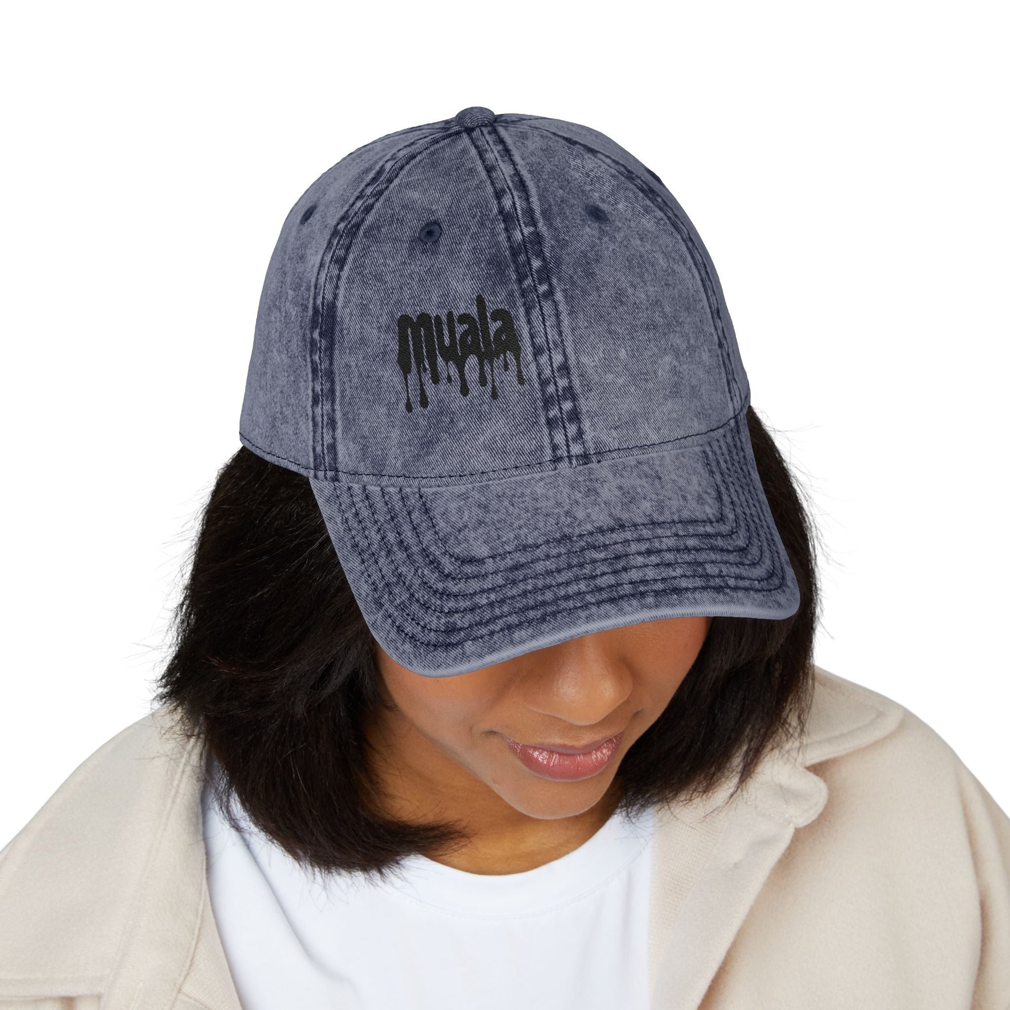 Woman wearing a distressed vintage blue Muala® "sunday pizza" cap with black embroidered logo on front panel