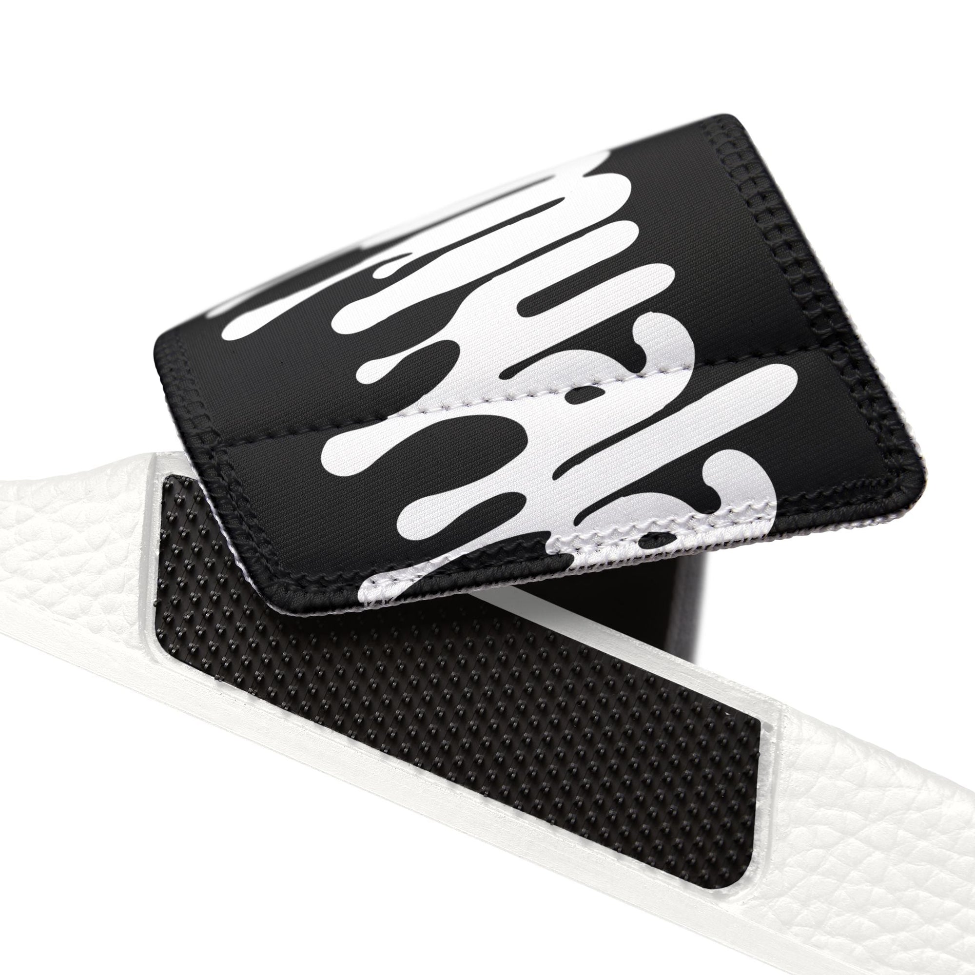Close-up of removable black and white strap detail for Muala® flip fat flop men's sandals with embossed grip padding.