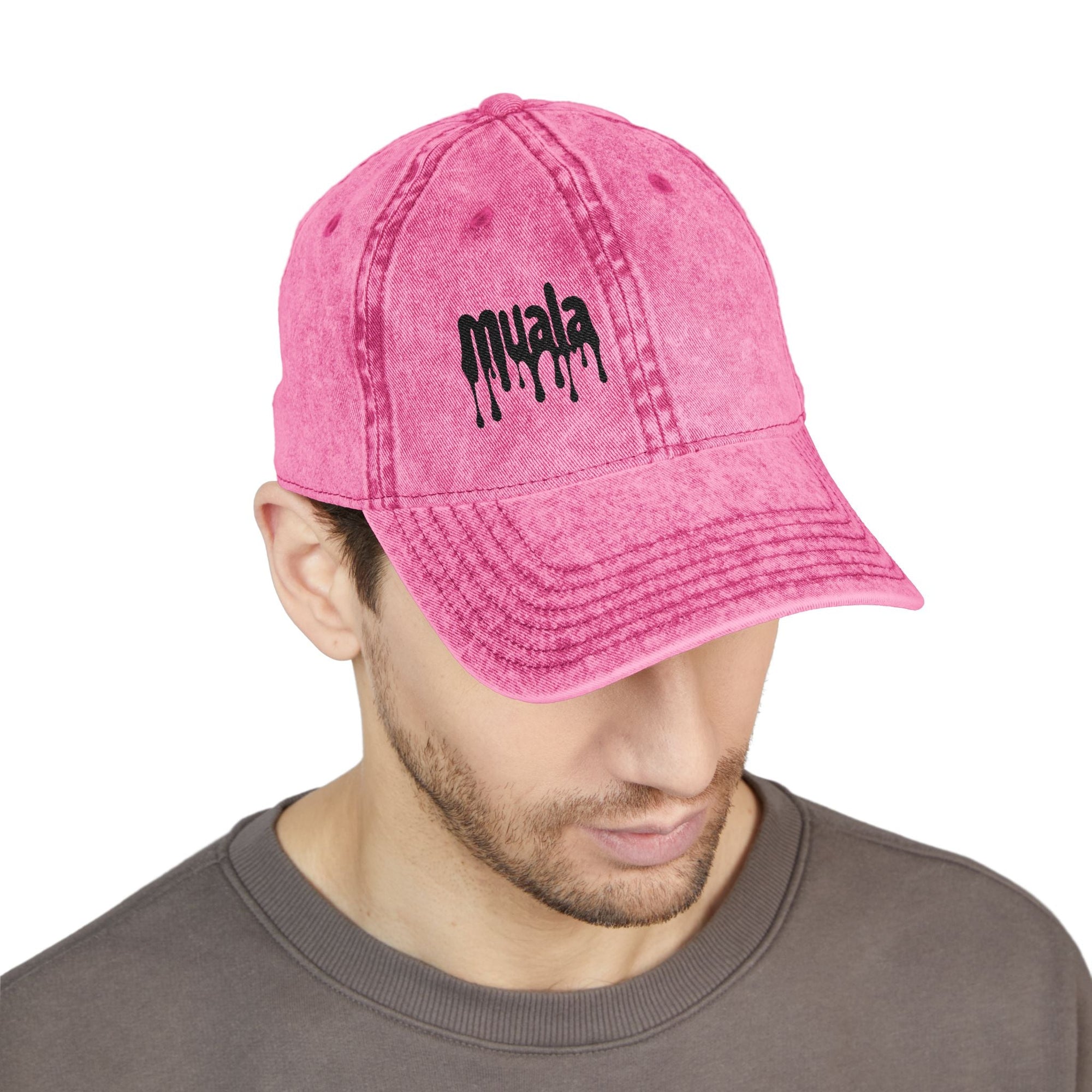 Man wearing a distressed pink Muala® "sunday pizza" cap with black embroidered logo on the right front panel