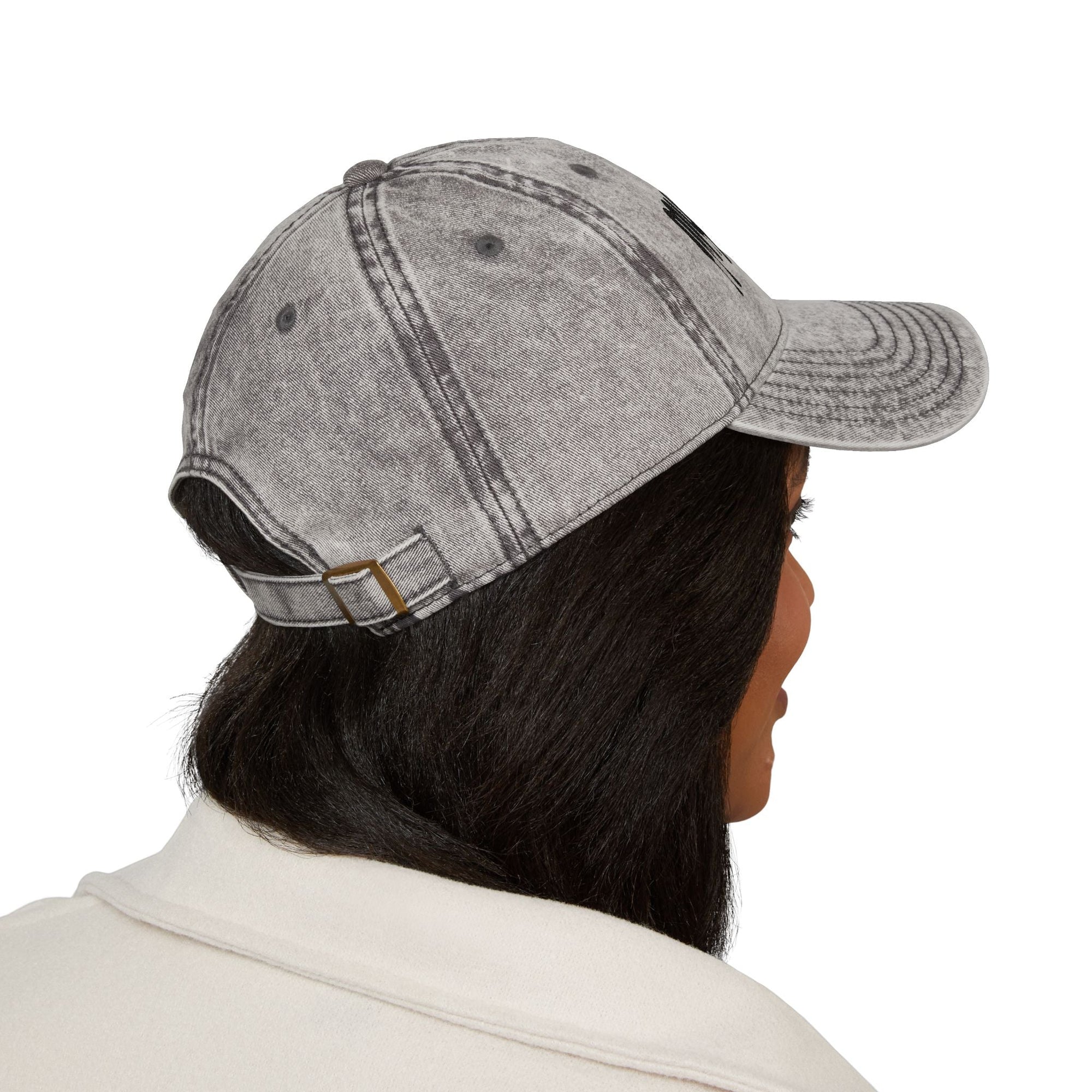 Side view of a person wearing a distressed gray Muala® "sunday pizza" cap with an adjustable antique brass metal snap buckle.
