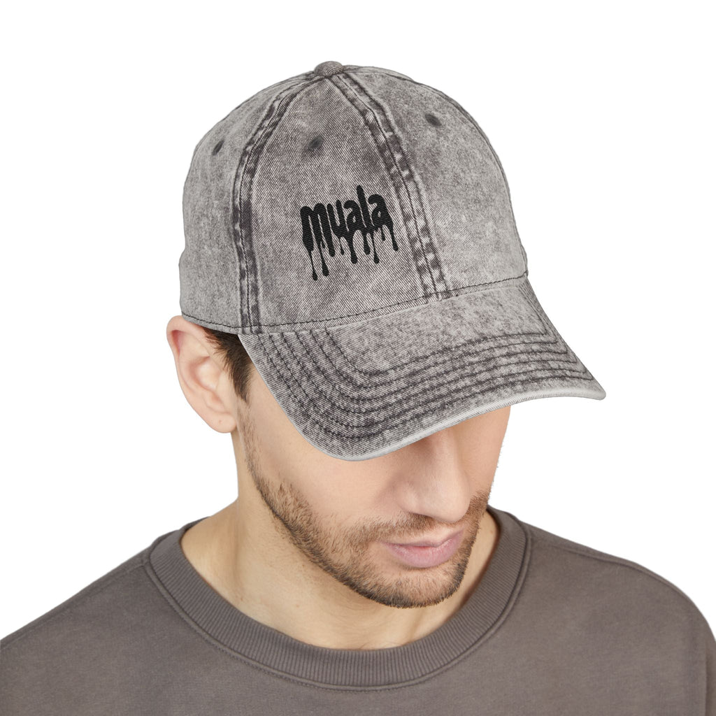 grey distressed cotton twill baseball cap with black embroidered muala logo on right front panel worn by
