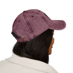 Purple distressed Muala® "sunday pizza" cap with black embroidered logo on front right panel, worn by person with dark hair.