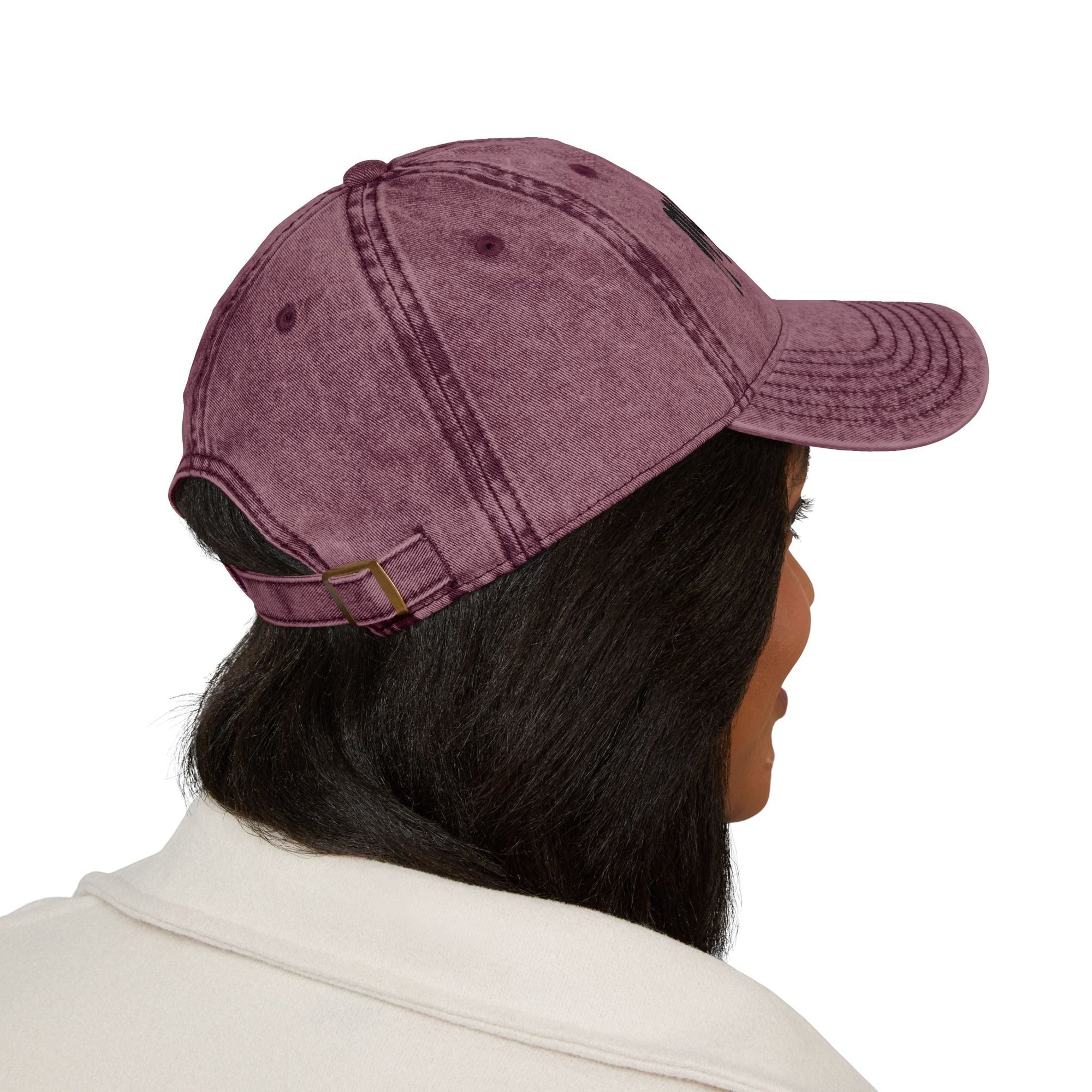 Purple distressed Muala® "sunday pizza" cap with black embroidered logo on front right panel, worn by person with dark hair.