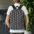 Person wearing muala® daily carry backpack with black and white pattern vol. 1 design on back.