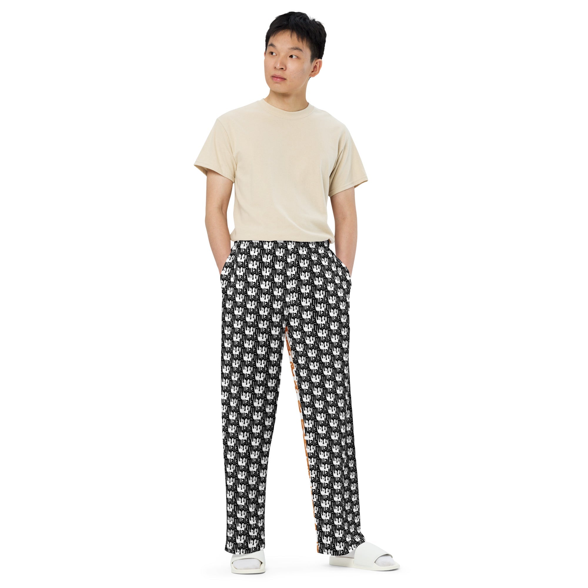 muala® "lazy AF" wide-leg comfort pants with black and white graphic print, elastic waistband with white drawstring, styled with beige t-shirt and white slides.