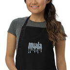 woman wearing black muala kitchen apron with gray embroidered logo and adjustable neck strap