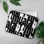 Black and white Muala® tech wrap laptop sleeve with bold Pattern Vol.1 streetwear graphics partially covering a laptop on a gray surface with green leaves nearby