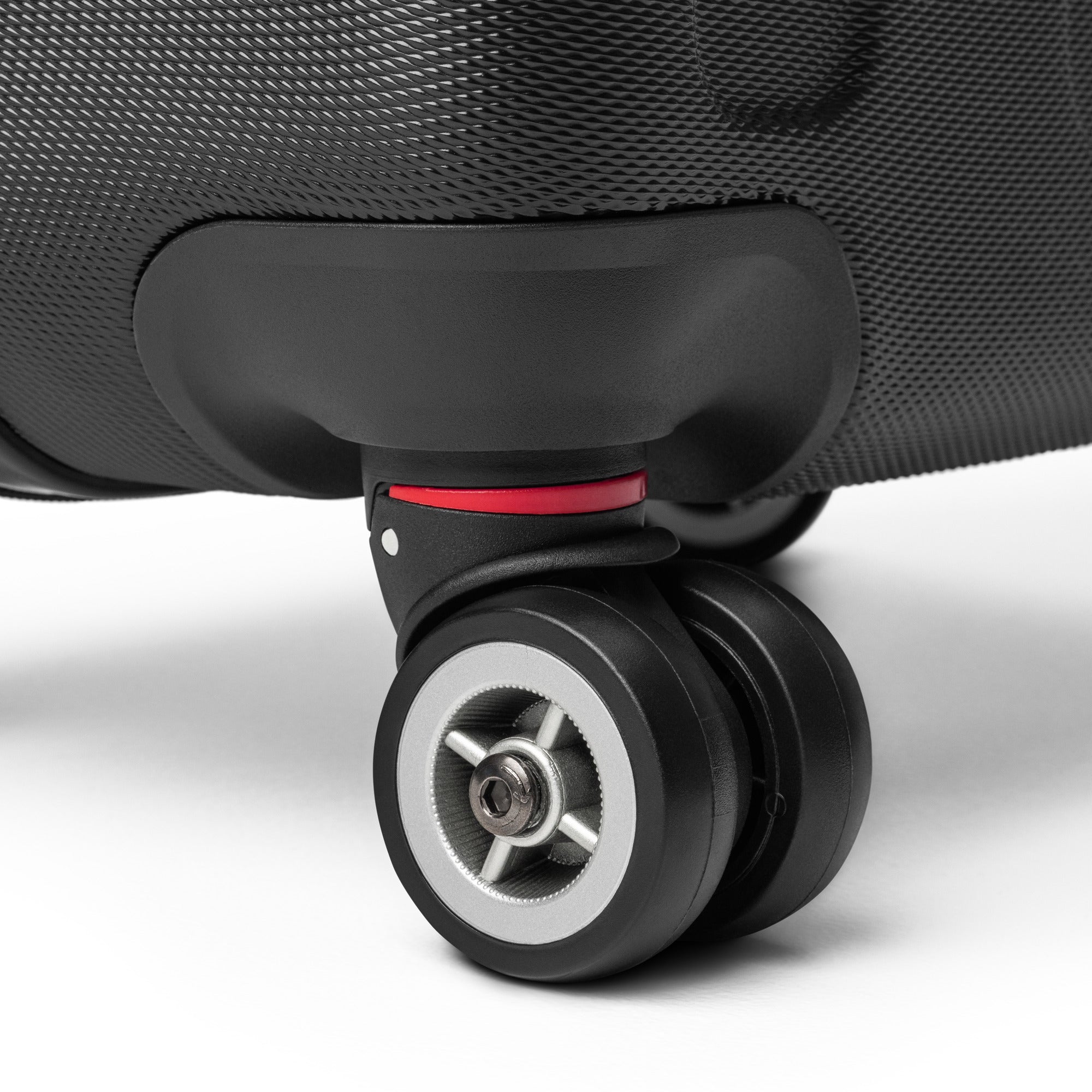 Close-up of black travel wrap suitcase 360-degree double wheels with red accent and textured polycarbonate shell