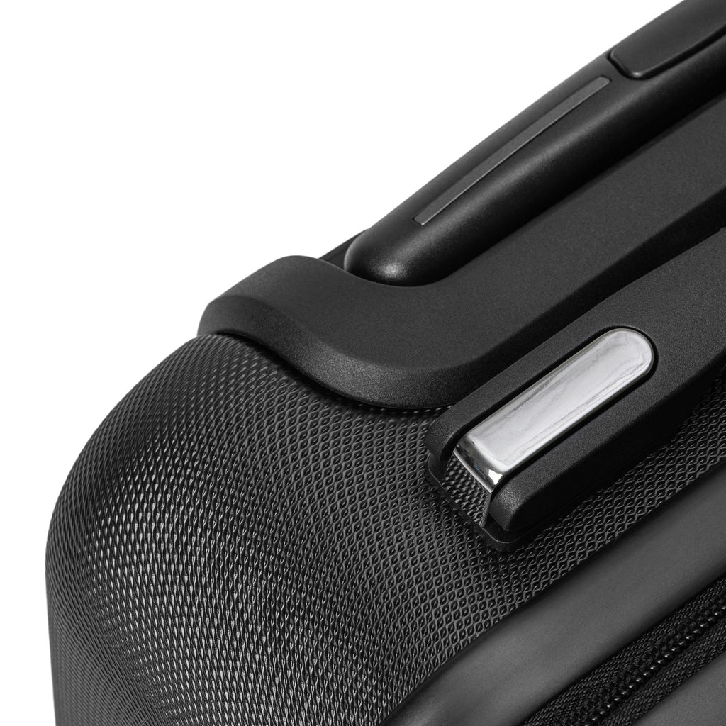 Close-up of black textured travel wrap suitcase corner with integrated lock and handle detailing