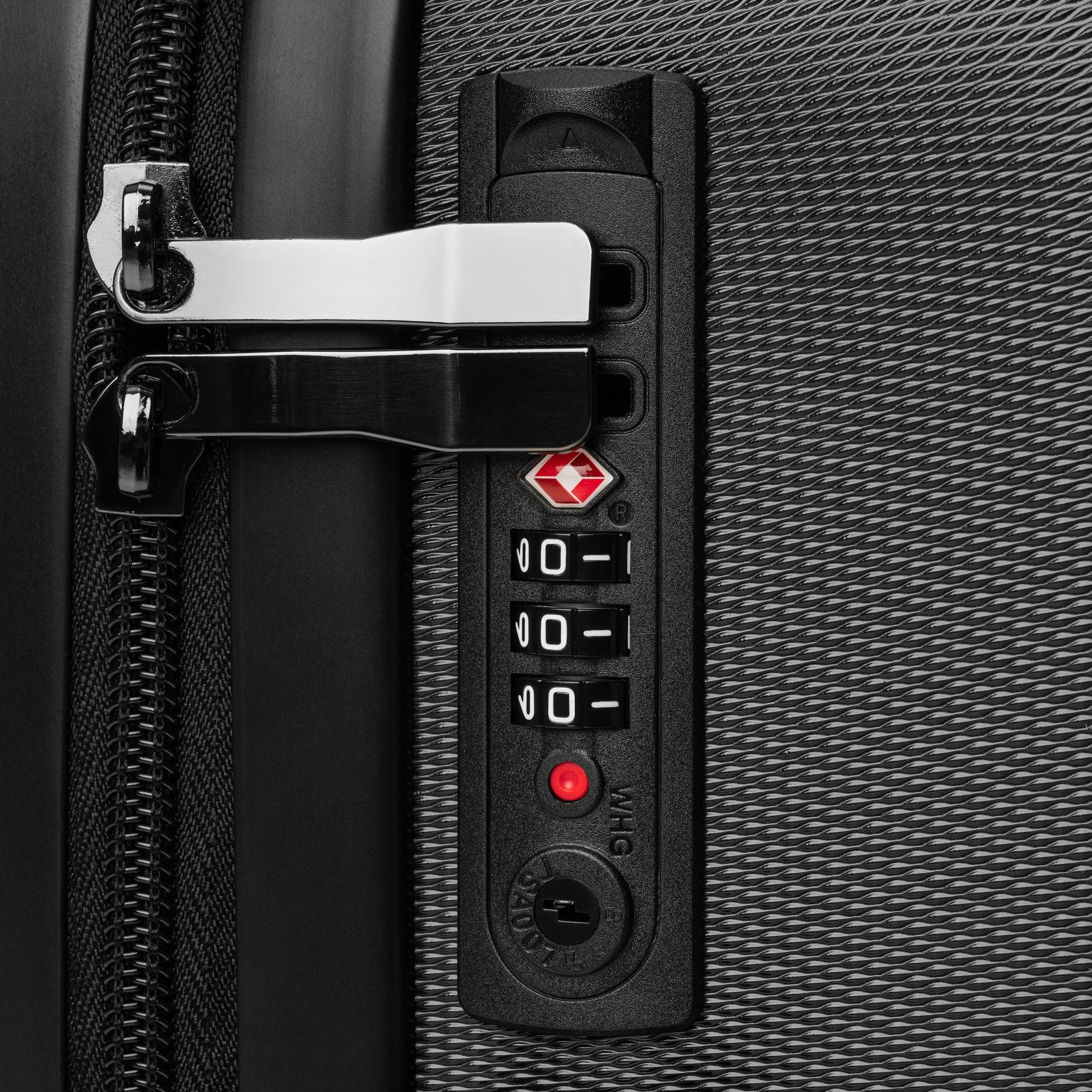 Close-up of TSA-friendly built-in combination lock on black polycarbonate travel wrap suitcase